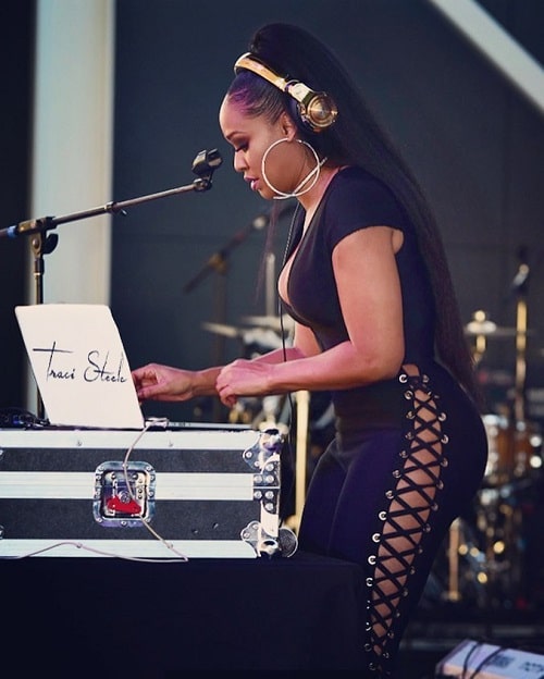 A picture of Traci Steele DJing.